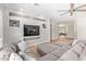 Comfortable living room featuring a large sectional sofa, wood-look tile floors, and recessed lighting at 15088 W Coolidge St, Goodyear, AZ 85395