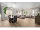 Bright living room and dining area featuring stylish decor and wood-look tile flooring at 15088 W Coolidge St, Goodyear, AZ 85395
