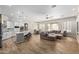 Spacious living room with wood-look tile flooring, recessed lighting, and a view to the backyard at 15088 W Coolidge St, Goodyear, AZ 85395