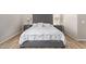 Comfortable main bedroom featuring a tufted headboard and matching nightstands at 15088 W Coolidge St, Goodyear, AZ 85395