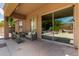 Relaxing covered patio featuring stone flooring and comfortable outdoor seating perfect for lounging at 15088 W Coolidge St, Goodyear, AZ 85395