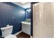 Chic powder room showcasing stylish wallpaper, a pedestal sink, and a convenient toilet for guests at 1525 E Southern Ave, Tempe, AZ 85282