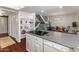 Open-concept kitchen with sleek countertop and modern appliances, seamlessly flowing into the dining area and stairs at 1525 E Southern Ave, Tempe, AZ 85282