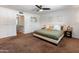 Spacious bedroom featuring neutral colors, ceiling fan and a view into the hall at 1525 E Southern Ave, Tempe, AZ 85282