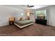 This main bedroom features stylish decor, including a ceiling fan and bedside lamps at 1525 E Southern Ave, Tempe, AZ 85282