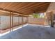 View of the open patio with a fan and concrete flooring, partially enclosed by a fence at 1525 E Southern Ave, Tempe, AZ 85282