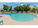 Community pool surrounded by seating areas, umbrellas, and lush greenery for a relaxing atmosphere at 1525 E Southern Ave, Tempe, AZ 85282