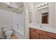 The full bathroom features a shower-tub combo and a wooden vanity at 16602 N 25Th St # 114, Phoenix, AZ 85032