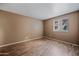This cozy bedroom features wood floors and a window providing natural light at 16602 N 25Th St # 114, Phoenix, AZ 85032