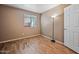 Bright bedroom with wood floors, a standing lamp, and natural light at 16602 N 25Th St # 114, Phoenix, AZ 85032