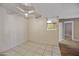This open concept living room features tile flooring, neutral paint, and a ceiling fan at 16602 N 25Th St # 114, Phoenix, AZ 85032