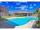 Community pool area with clear blue water and seating at 16602 N 25Th St # 114, Phoenix, AZ 85032