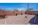 Enclosed backyard with rock landscaping, brick walls, and potted plants at 17403 N 16Th Pl, Phoenix, AZ 85022