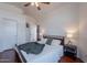 Bright bedroom features a ceiling fan, warm wood floors, and white walls at 17403 N 16Th Pl, Phoenix, AZ 85022