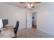 Carpeted bedroom featuring a ceiling fan and a door to another room at 17403 N 16Th Pl, Phoenix, AZ 85022