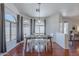 Dining area with a modern chandelier, arched windows, and gray curtains at 17403 N 16Th Pl, Phoenix, AZ 85022