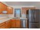 Bright kitchen showcasing wood cabinets, stainless steel appliances, and a window with a view at 17403 N 16Th Pl, Phoenix, AZ 85022