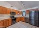 Well-lit kitchen featuring stainless steel appliances, spacious countertops, and wooden cabinetry at 17403 N 16Th Pl, Phoenix, AZ 85022