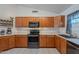 Functional kitchen featuring wooden cabinets, modern appliances, and ample counter space at 17403 N 16Th Pl, Phoenix, AZ 85022