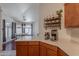 Kitchen countertop with coffee maker setup and view to the dining area with large bright windows at 17403 N 16Th Pl, Phoenix, AZ 85022