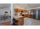 Open concept kitchen with wooden cabinets, stainless appliances, and adjacent breakfast bar and living space at 17403 N 16Th Pl, Phoenix, AZ 85022