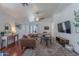 Bright living room featuring hardwood floors, a ceiling fan, and access to the backyard at 17403 N 16Th Pl, Phoenix, AZ 85022