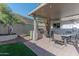 Backyard featuring outdoor kitchen, patio cover, pavers, and lush greenery at 1749 E Medlock Dr, Phoenix, AZ 85016