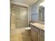 Bathroom featuring a glass-enclosed shower, patterned wallpaper, and modern vanity at 17841 N Del Webb Blvd, Sun City, AZ 85373