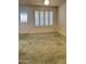 Bright bedroom featuring neutral carpet, white shutters and a view to the exterior at 17841 N Del Webb Blvd, Sun City, AZ 85373