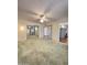 Spacious living room with neutral carpet, ceiling fan, and sliding mirrored closet doors at 17841 N Del Webb Blvd, Sun City, AZ 85373
