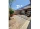 Private patio space with awnings, desert landscaping, and tiled area, perfect for outdoor living at 17841 N Del Webb Blvd, Sun City, AZ 85373