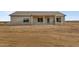 Backyard view of a new single Gathering home featuring an expansive patio and desert landscape at 22352 W Gamble Ln, Wittmann, AZ 85361