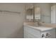 Bright bathroom featuring a modern vanity, faucet, and a large mirror with views at 22352 W Gamble Ln, Wittmann, AZ 85361