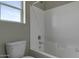 Clean bathroom features white tile tub and shower combo next to a toilet at 22352 W Gamble Ln, Wittmann, AZ 85361