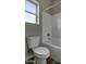 Bathroom features white tile tub and shower combo next to a toilet and small window at 22352 W Gamble Ln, Wittmann, AZ 85361