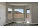 Bedroom featuring a bay window with a view, light-colored walls, and wood-look flooring at 22352 W Gamble Ln, Wittmann, AZ 85361