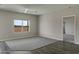 Cozy bedroom featuring wood-like floors, and plenty of natural light from a window with desert views at 22352 W Gamble Ln, Wittmann, AZ 85361