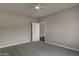 Neutral bedroom with a ceiling fan, gray carpet, and an ensuite door at 22352 W Gamble Ln, Wittmann, AZ 85361