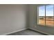 Bedroom with carpet and neutral walls boasts a large window with views of the natural desert surroundings at 22352 W Gamble Ln, Wittmann, AZ 85361