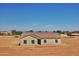 Front exterior of a single-story home with a simple, clean design and natural desert surroundings at 22352 W Gamble Ln, Wittmann, AZ 85361