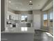 Well-lit kitchen with stainless steel appliances, white cabinetry, and ample counter space at 22352 W Gamble Ln, Wittmann, AZ 85361