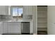 Kitchen with white cabinets and stainless steel dishwasher next to the pantry at 22352 W Gamble Ln, Wittmann, AZ 85361