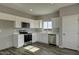 Bright kitchen featuring white cabinets, stainless steel appliances, and wood-look flooring at 22352 W Gamble Ln, Wittmann, AZ 85361