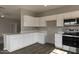 Open concept kitchen with white cabinets, a peninsula, and stainless steel appliances at 22352 W Gamble Ln, Wittmann, AZ 85361