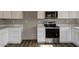 Kitchen view showcasing stainless steel range, microwave, and white cabinets with counter tops at 22352 W Gamble Ln, Wittmann, AZ 85361