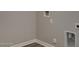 This laundry room has vinyl flooring, neutral walls and all the utility connections ready for appliances at 22352 W Gamble Ln, Wittmann, AZ 85361