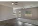 Spacious living room with modern flooring, fan, and natural light enhancing the area's appeal at 22352 W Gamble Ln, Wittmann, AZ 85361