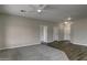 Large living room with a combination of carpet and wood-look flooring, and ceiling fans at 22352 W Gamble Ln, Wittmann, AZ 85361