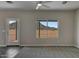 Living area features a door leading outside and a large window with scenic views and neutral walls at 22352 W Gamble Ln, Wittmann, AZ 85361