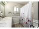 Bathroom featuring a single sink vanity, decorative mirror and a floral shower curtain at 253 N Fraser Dr, Mesa, AZ 85203